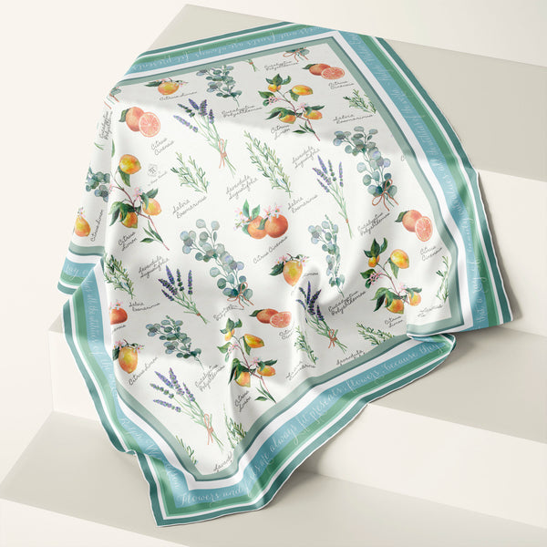 Watercolor botanical illustration silk scarf with aromatic plants, fruit and herbs by Boston artist Darya Karenski. Green border with script of Ralph Waldo Emerson quote