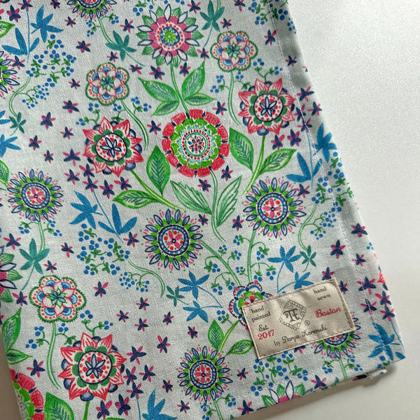 Gift handmade linen towel made in the USA, artist print in soft blues, greens with a pop of red and pink