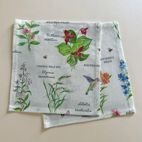 Cloth cocktail napkin with watercolor wild flowers and their botanical names