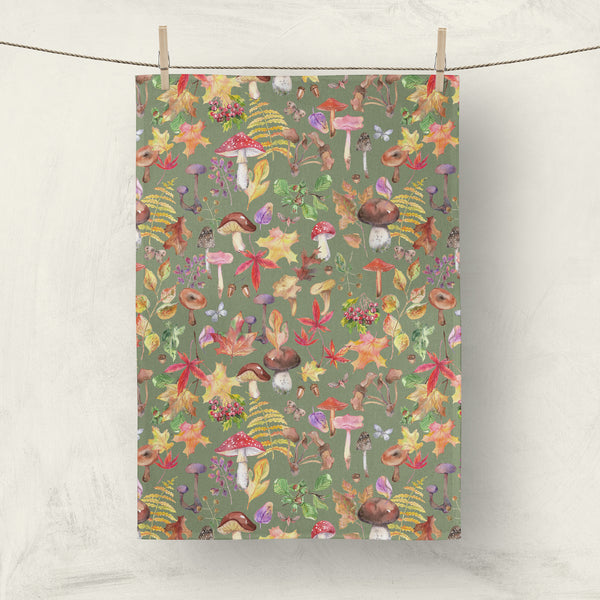 Olive green towel with bright fall watercolor leaves and mushrooms by artist Darya Karenski
