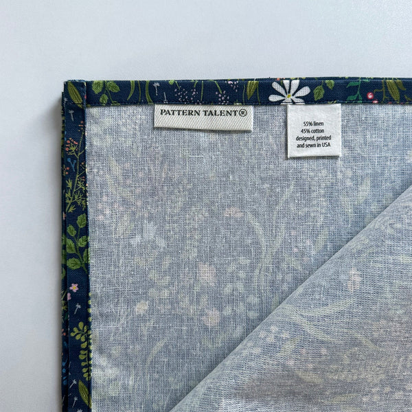 Quality handmade dinner napkin with a botanical print on navy fabric. Made in Massachusetts