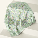 Silk scarf by Darya Karenski with meadow plants and herbs and a Ralph Waldo Emerson quote in script